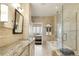 Elegant bathroom with a view to the main bedroom, marble tile and glass shower at 5455 Landmark Pl # 1009, Greenwood Village, CO 80111