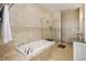Elegant bathroom featuring marble tile and a soaking tub with shower at 5455 Landmark Pl # 1009, Greenwood Village, CO 80111