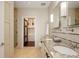 Luxurious bathroom featuring double sinks, granite countertops, and walk-in shower at 5455 Landmark Pl # 1009, Greenwood Village, CO 80111
