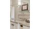 Luxurious bathroom featuring granite countertops, glass shelving, and neutral finishes at 5455 Landmark Pl # 1009, Greenwood Village, CO 80111