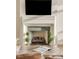 Close up of decorative fireplace and mantel with dark wood coffee table at 5455 Landmark Pl # 1009, Greenwood Village, CO 80111