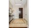 Foyer with stylish tiled floor, console table and contemporary lighting at 5455 Landmark Pl # 1009, Greenwood Village, CO 80111