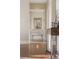 Hallway with hardwood floors leading to other rooms; decorative mirror at 5455 Landmark Pl # 1009, Greenwood Village, CO 80111