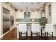 Beautiful kitchen featuring custom cabinets, a green tile backsplash, stainless appliances, and hardwood floors at 5455 Landmark Pl # 1009, Greenwood Village, CO 80111