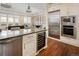 Modern kitchen with stainless steel appliances, wine fridge and granite countertops at 5455 Landmark Pl # 1009, Greenwood Village, CO 80111
