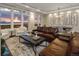 Bright and airy living room with a brown leather couch, stunning views, and ample natural light at 5455 Landmark Pl # 1009, Greenwood Village, CO 80111
