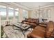 Bright and airy living room with a brown leather couch, stunning views, and ample natural light at 5455 Landmark Pl # 1009, Greenwood Village, CO 80111