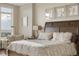 Comfortable main bedroom with a sitting area, a large window and stylish decor at 5455 Landmark Pl # 1009, Greenwood Village, CO 80111