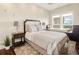 Comfortable bedroom with a sitting area near the window and carpeted floor at 5455 Landmark Pl # 1009, Greenwood Village, CO 80111
