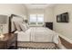 Comfortable bedroom with a sitting area near the window and an mounted TV at 5455 Landmark Pl # 1009, Greenwood Village, CO 80111