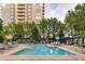 Community pool with lounge chairs and umbrellas, perfect for relaxation at 5455 Landmark Pl # 1009, Greenwood Village, CO 80111