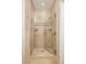 Luxurious walk-in shower with neutral tile finishes, glass doors and dual fixtures at 5455 Landmark Pl # 1009, Greenwood Village, CO 80111