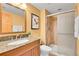 Well-lit bathroom with a granite vanity, a glass-enclosed shower, and modern fixtures at 3644 Sunchase Dr, Castle Rock, CO 80109