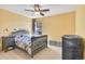 Cozy bedroom featuring carpeted floors, a ceiling fan, neutral colors, and a window that provides natural lighting at 3644 Sunchase Dr, Castle Rock, CO 80109