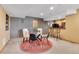 Inviting dining area with a glass table and seating for four, adjacent to a bar area at 3644 Sunchase Dr, Castle Rock, CO 80109