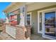 Inviting front porch with brick columns, white railings, and space to enjoy the outdoors at 3644 Sunchase Dr, Castle Rock, CO 80109