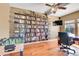 Functional home office with built-in bookshelves, a TV, and a foosball table at 3644 Sunchase Dr, Castle Rock, CO 80109