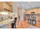 Kitchen with light wood cabinets, granite counters, stainless steel appliances, and a kitchen desk at 3644 Sunchase Dr, Castle Rock, CO 80109