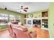 Spacious living room featuring a stone fireplace and ample natural light at 3644 Sunchase Dr, Castle Rock, CO 80109