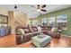 Bright living room with a large brown leather sectional and great natural light at 3644 Sunchase Dr, Castle Rock, CO 80109