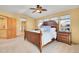 Well-lit main bedroom featuring a ceiling fan, carpeted floors, and a Primary bathroom with a shower behind the door at 3644 Sunchase Dr, Castle Rock, CO 80109