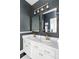 Stylish bathroom featuring a double vanity with gold hardware and contrasting dark gray walls at 11745 Newton St, Westminster, CO 80031