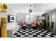 Entertaining game room with a vintage pinball machine, diner-style seating, and a black and white checkered floor at 11745 Newton St, Westminster, CO 80031