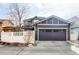 Well-maintained garage featuring a carriage-style door and a convenient driveway at 11745 Newton St, Westminster, CO 80031