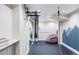 Well-equipped home gym with climbing ropes, gymnastic rings, a pull-up bar, and ample workout space at 11745 Newton St, Westminster, CO 80031