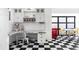 Retro-style kitchenette with black and white checkered floors, white cabinetry, and vintage soda-themed decor at 11745 Newton St, Westminster, CO 80031