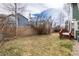 Fenced backyard featuring a fire pit, lawn area, and a wood deck, creating an ideal space for outdoor enjoyment at 19634 E Clear Creek Trl, Parker, CO 80134