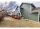 A backyard featuring a wooden deck for outdoor entertaining with a lush lawn, and well-maintained siding at 19634 E Clear Creek Trl, Parker, CO 80134