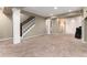 Spacious finished basement with carpet flooring and stairway to upper level at 19634 E Clear Creek Trl, Parker, CO 80134