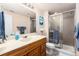 Bright bathroom featuring a glass enclosed shower, single sink vanity, and tile floors at 19634 E Clear Creek Trl, Parker, CO 80134