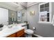 Cozy half bathroom with neutral paint, wood vanity, and a window providing natural light at 19634 E Clear Creek Trl, Parker, CO 80134