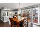 Dining room with wood floors, sliding glass doors to deck, and an open floorplan that flows into the kitchen at 19634 E Clear Creek Trl, Parker, CO 80134