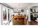 Dining room with wood floors, sliding glass doors to deck, and an open floorplan that flows into the living room at 19634 E Clear Creek Trl, Parker, CO 80134