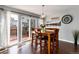 Dining room with wood floors, sliding glass doors to deck, and an open floorplan that flows into the living room at 19634 E Clear Creek Trl, Parker, CO 80134