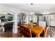 Open-concept dining room with wood floors, a modern chandelier, and easy access to the living room at 19634 E Clear Creek Trl, Parker, CO 80134