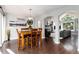 Open-concept dining room with wood floors, a modern chandelier, and easy access to the living room at 19634 E Clear Creek Trl, Parker, CO 80134