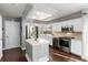 Modern kitchen with white cabinets, stainless steel appliances, an island, and a bright, sunny window at 19634 E Clear Creek Trl, Parker, CO 80134