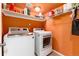 Laundry room equipped with modern appliances and shelving for storage at 19634 E Clear Creek Trl, Parker, CO 80134