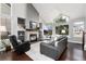 Bright living room with vaulted ceilings, stone fireplace, large windows, and a comfortable leather sofa at 19634 E Clear Creek Trl, Parker, CO 80134