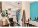 This bathroom features a toilet, shower, cabinet, and bathtub, with a large gray towel hanging on the wall at 15685 E 50Th Ave, Denver, CO 80239