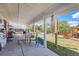 Spacious covered patio includes comfortable seating, a hammock, and a grill for outdoor enjoyment at 15685 E 50Th Ave, Denver, CO 80239