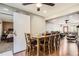 This dining room has a sliding barn door to the bedroom, with wood floors and a view into the living room at 15685 E 50Th Ave, Denver, CO 80239