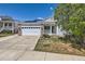 Well-kept single-Gathering home featuring a welcoming porch, brick accents, and solar panels on the roof at 15685 E 50Th Ave, Denver, CO 80239