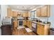 Well-equipped kitchen with wood cabinets, stainless steel appliances, and granite countertops at 15685 E 50Th Ave, Denver, CO 80239