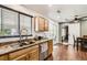 This home features a granite countertop, stainless steel appliances, and a large window with views of the outdoors at 15685 E 50Th Ave, Denver, CO 80239