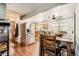 This home features a kitchen and dining room combination, stainless steel refrigerator, and wooden table and chairs at 15685 E 50Th Ave, Denver, CO 80239